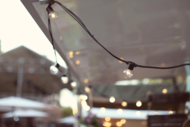 Blurred view of garland as decor outdoors