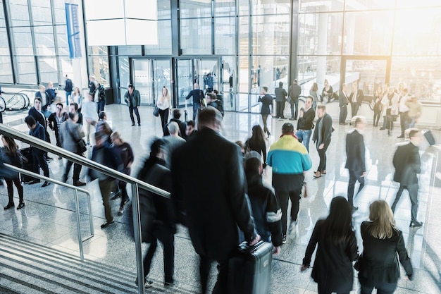 Blurred visitors rushing on a entrance at a tradeshow hall.\
ideal for websites and magazines layouts