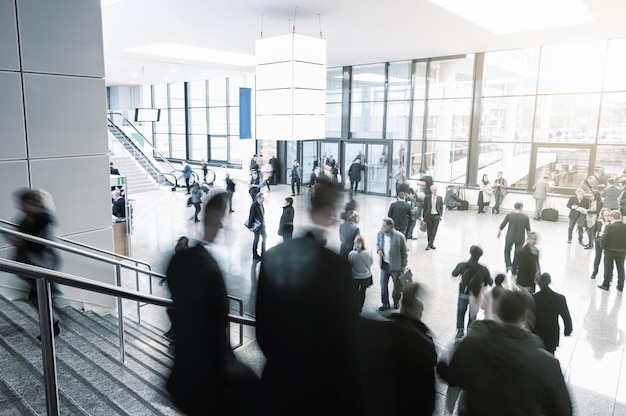 Blurred visitors rushing on a entrance of a tradeshow. ideal for websites and magazines layouts