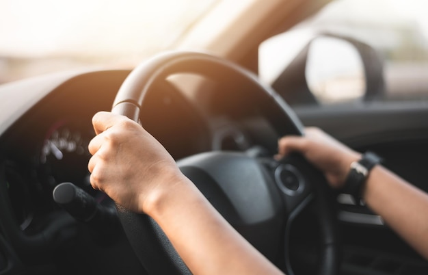 Blurred of Woman Holding Steering Wheel to Driving a Car for Driver License Test at School Transportation Concept