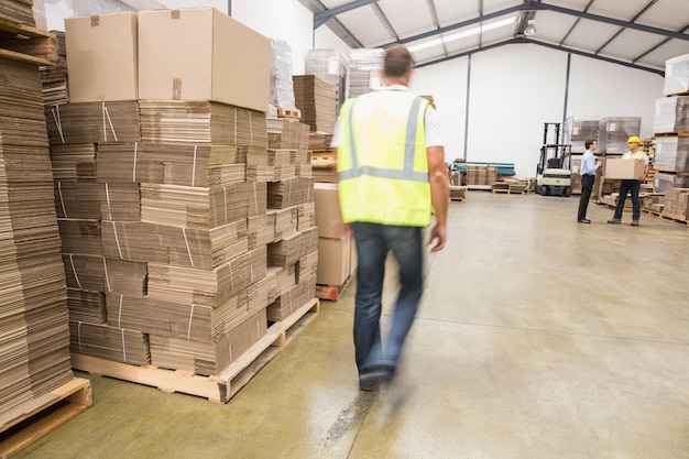 Blurred worker walking in warehouse