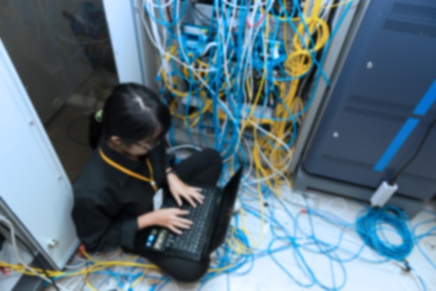 Blurry of Asian engineer working in the server roomCheck the connection problems of computer networksThailand people