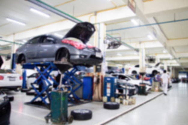 Blurry background car repair station in the garage with soft\
light. car maintanance.