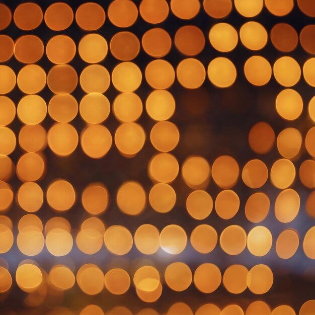 A blurry background of lights with a blur of yellow and orange circles
