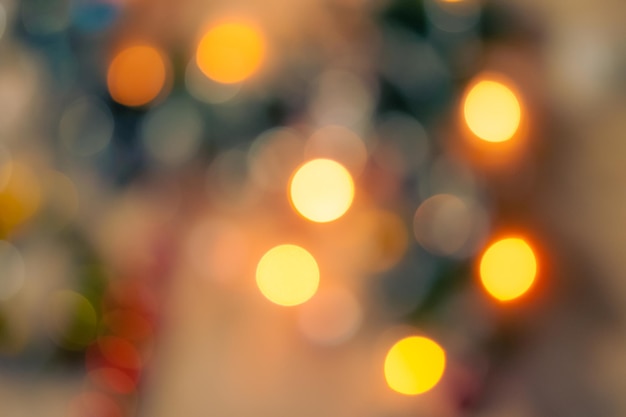 A blurry image of a street with lights in the background