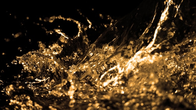 Blurry images of oil liquid from diesel gasoline splashing and moving up to the air on black