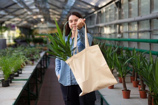 blurry portrait of woman holding yucca in the cotton shoppercopy space