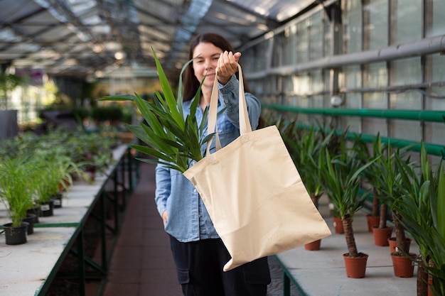 Blurry portrait of woman holding yucca in the cotton shoppercopy space