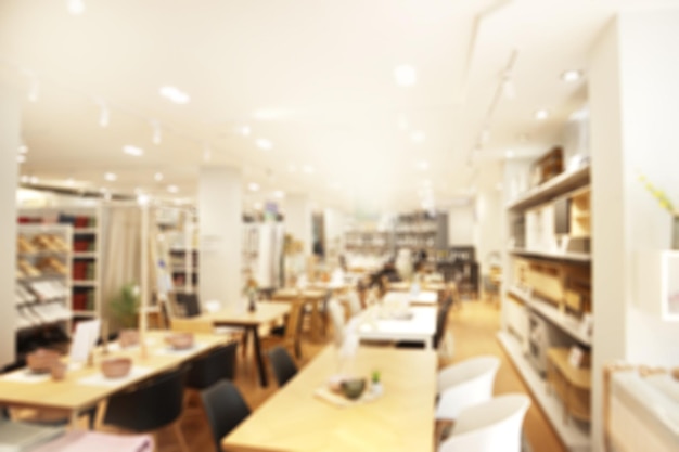 A blurry view of a shop offering home decoration furniture and a dining table