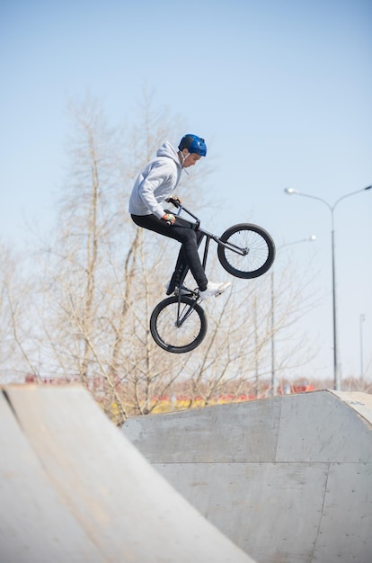 A bmx rider in the skatepark in the air