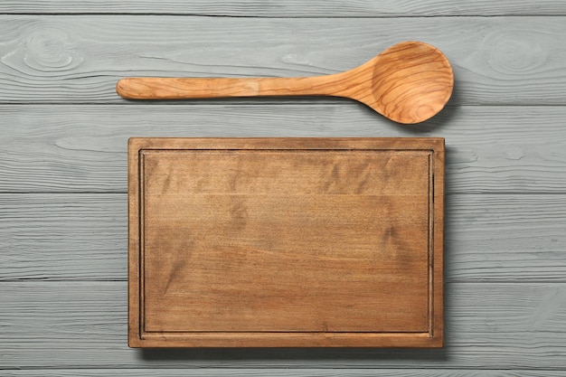 Board and spoon on wooden background