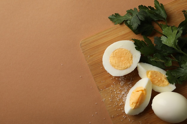 Board with boiled eggs, salt and parsley