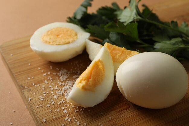 Board with boiled eggs, salt and parsley