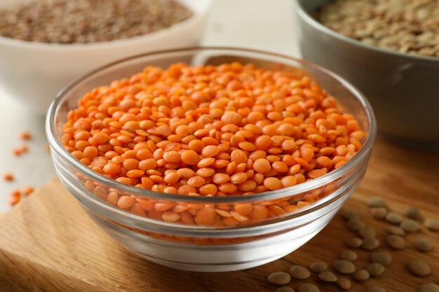 Board with bowls with legumes close-up