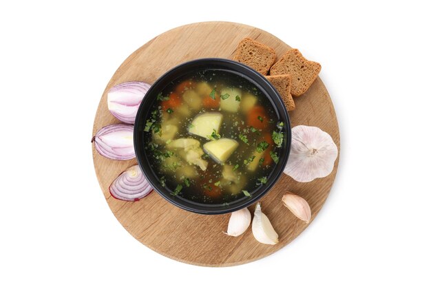 Board with chicken soup and ingredients isolated on white background