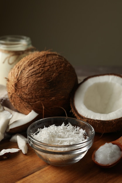 Board with coconut and coconut flakes on gray table