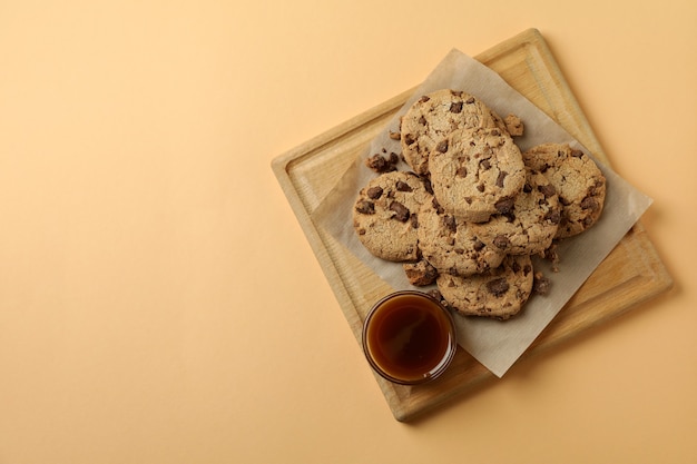 Board with cookies and caramel on beige