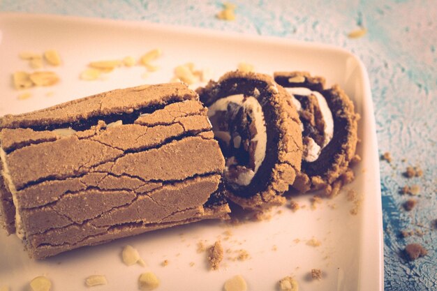 Board with delicious cake on table