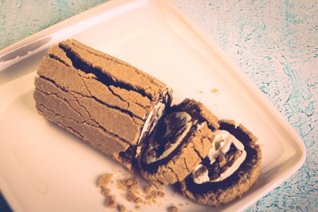 Board with delicious cake on table