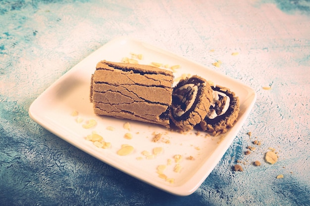 Board with delicious cake on table