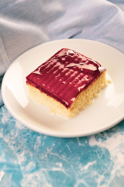 Board with delicious cake on table