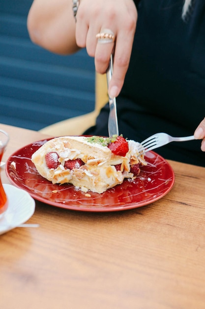 Board with delicious cake on table