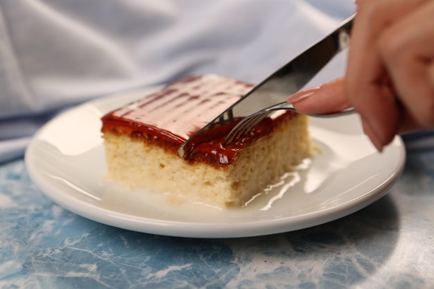 Board with delicious cake on table