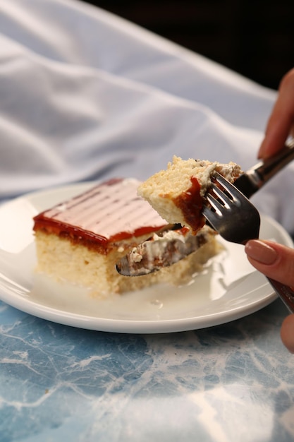 Board with delicious cake on table