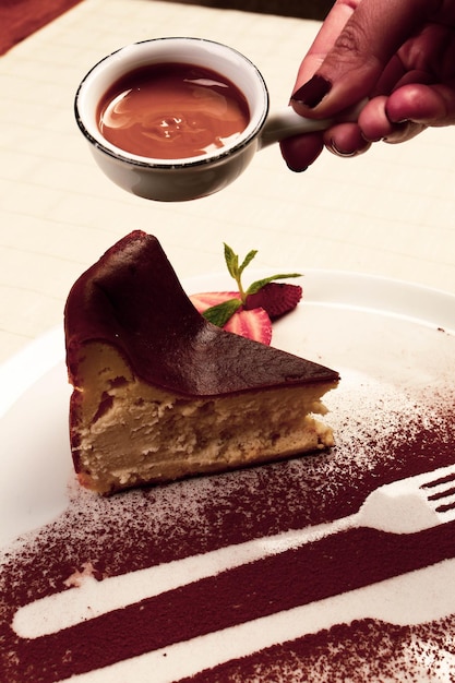 Board with delicious cake on table