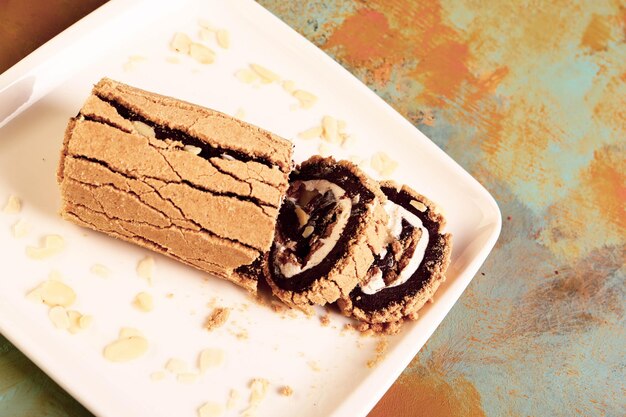 Board with delicious cake on table