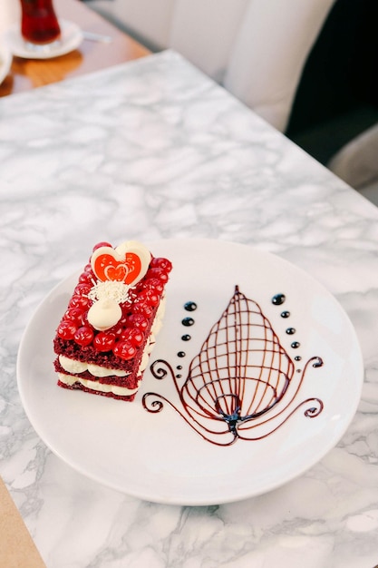 Board with delicious cake on table