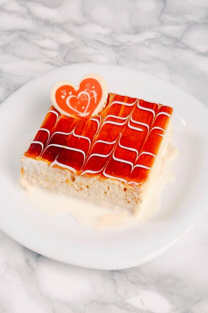 Board with delicious cake on table