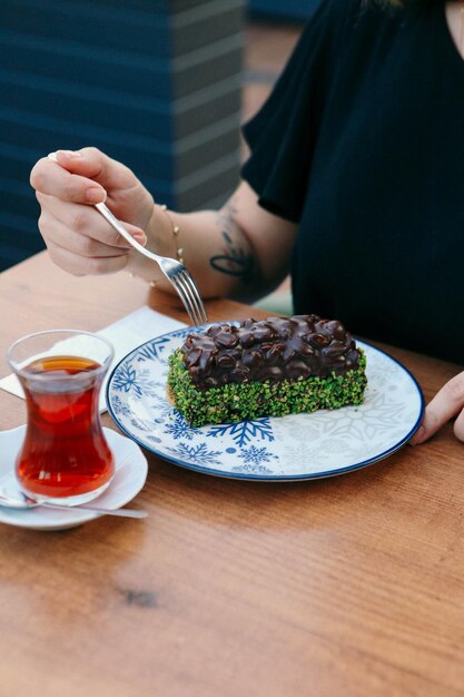 Board with delicious cake on table