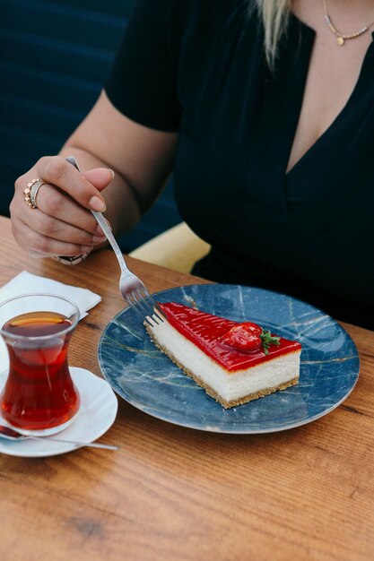 Board with delicious cake on table