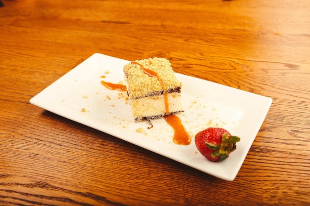 Board with delicious cake on table