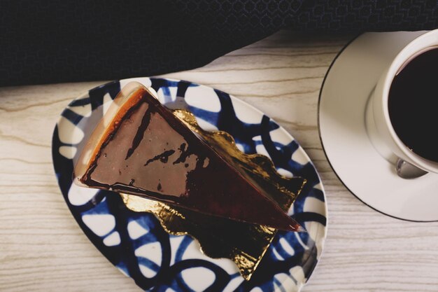 Board with delicious cake on table