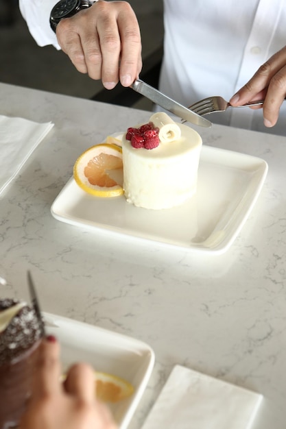 Board with delicious cake on table