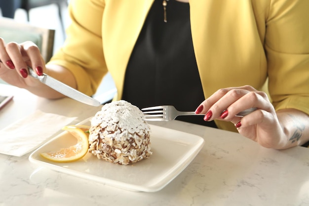 Board with delicious cake on table