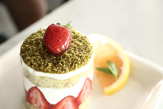 Board with delicious cake on table