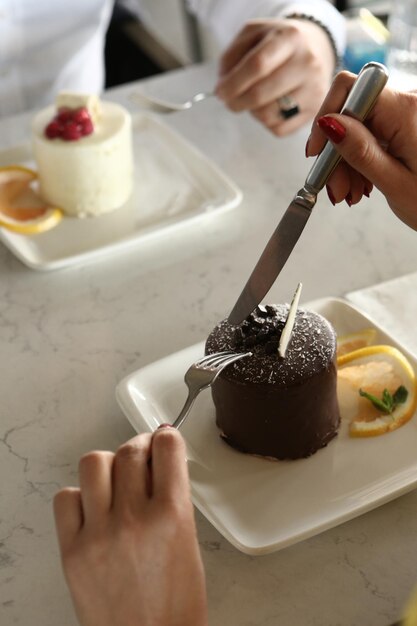 Board with delicious cake on table