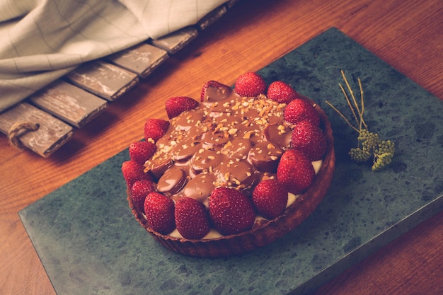 Board with delicious cake on table