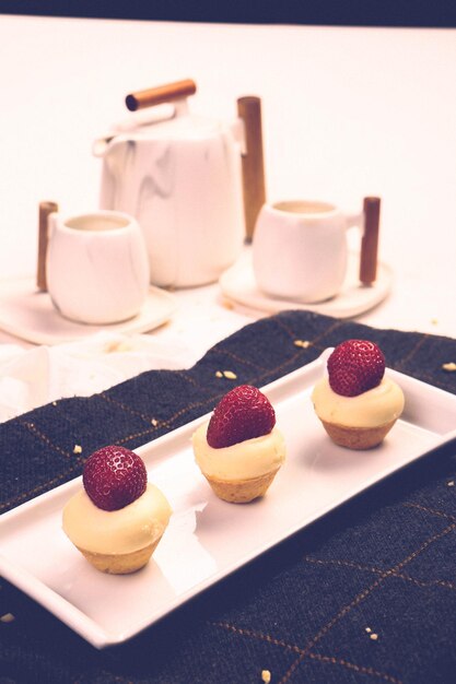 Board with delicious cake on table