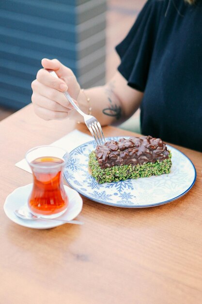 Board with delicious cake on table