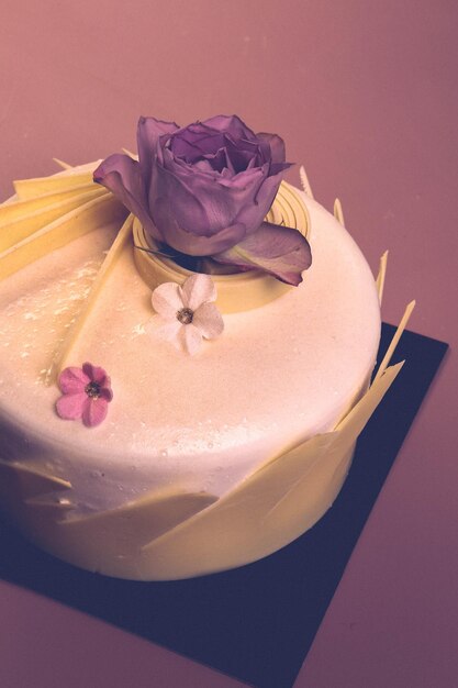 Board with delicious cake on table