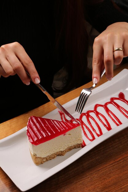 Board with delicious cake on table