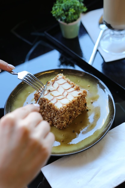 Board with delicious cake on table