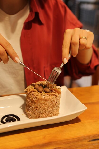 Board with delicious cake on table