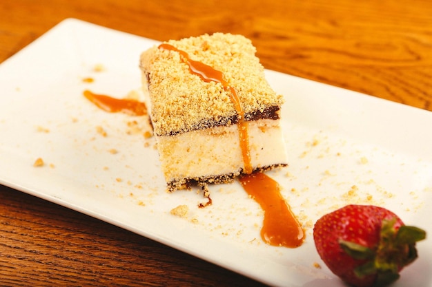 Board with delicious cake on table