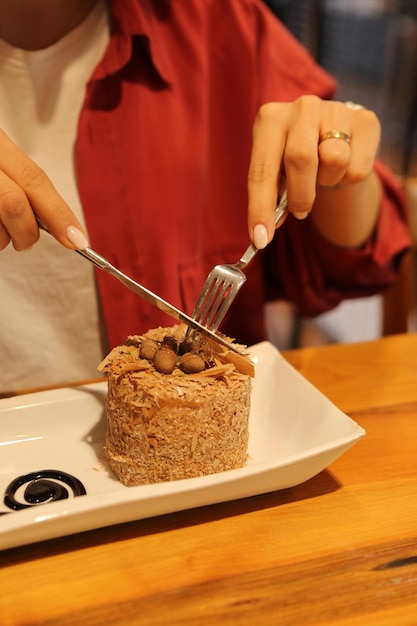 Board with delicious cake on table