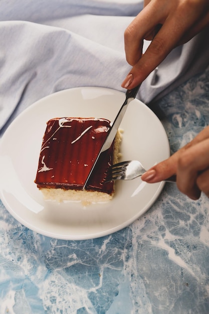 Board with delicious cake on table